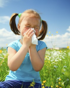 Little girl is blowing her nose