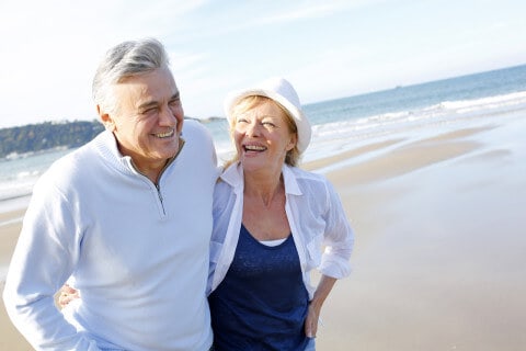 Senior couple walking on the beach 