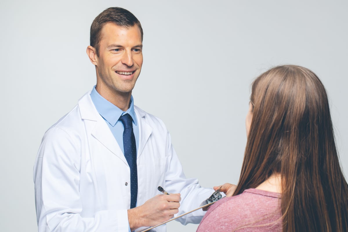Dr. Josh Axe discussing care with a patient