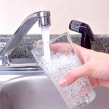 tap water being poured into a glass