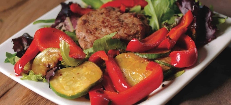 Turkey burger on greens