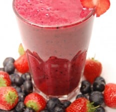 coconut berry Smoothie with berries around it